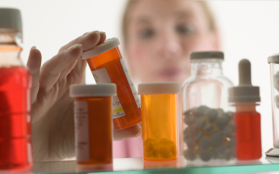 Woman looks at her prescription medication.