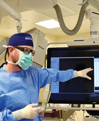 Surgeon pointing at screen