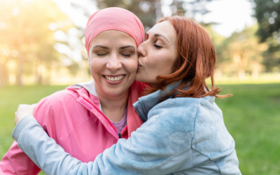 Woman embraces friend with cancer.