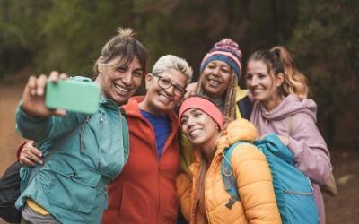 Women on hike stop and pose for a picture.