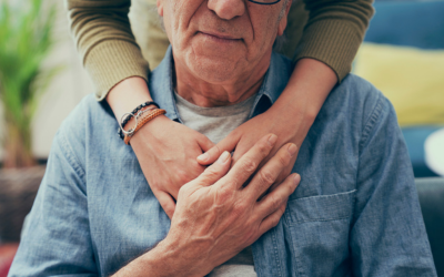 Person embraces older man.