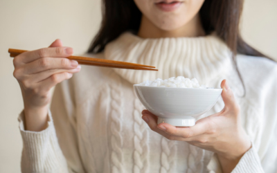 Woman prepares to eat rice dish.