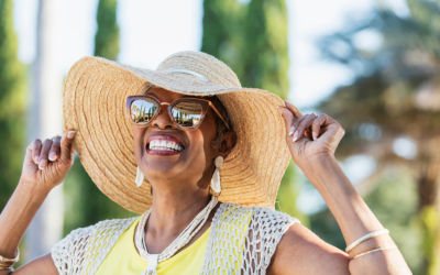 Senior woman smiling in sun hat.