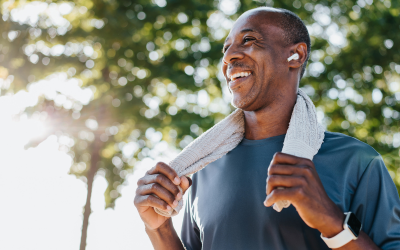 Man with earpods cools off after run.