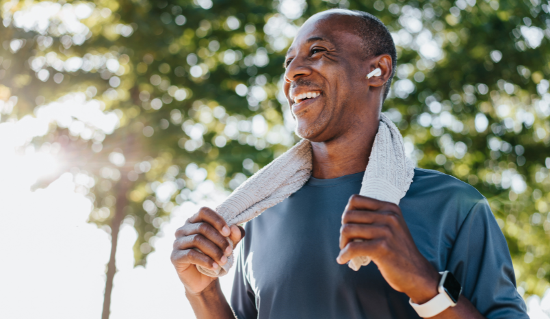 Man with earpods cools off from run.