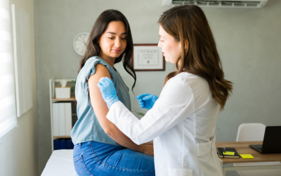 Doctor prepares vaccine for patient.