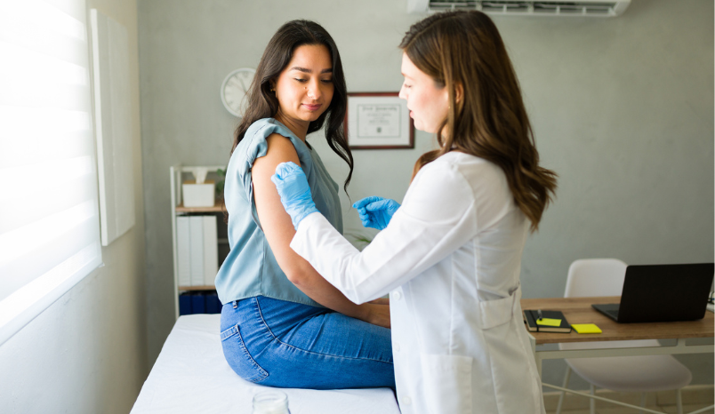 Doctor prepares vaccine for patient.