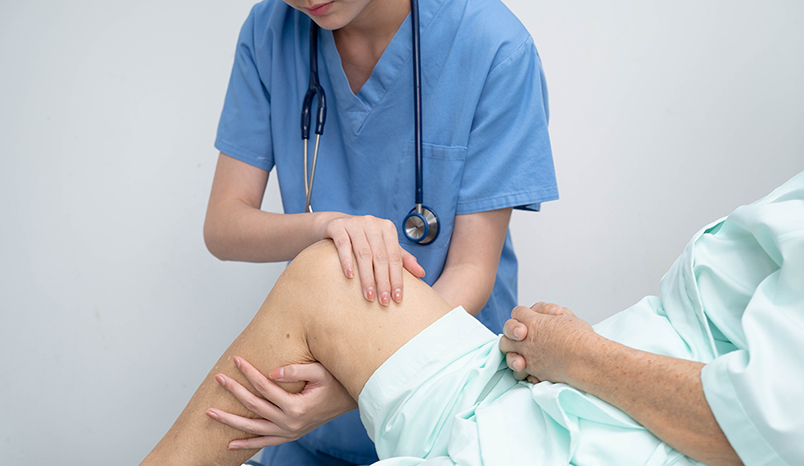 Provider examining patient's knee
