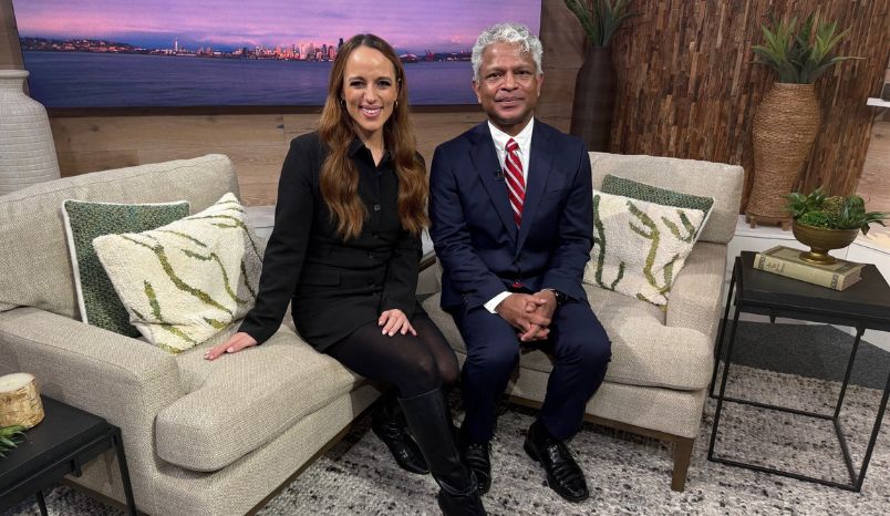 Seen on King 5 New Day NW Overlake’s Sports & Spine Doctor Llewellyn Packia-Raj sitting on couch with Kelly the host