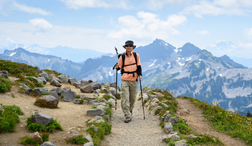 Front view of a man hiking at Skyline Loop Trail. Mt Rainier National Park. Washington State.