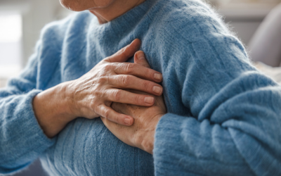 Woman clutches heart in pain.