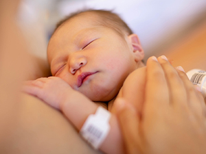 Newborn baby held by mother