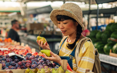 Woman at farmers market looks at fruit stall