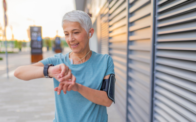 Athletic mature woman monitoring her running performance on smartwatch