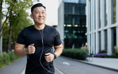 Young Asian Man Smiles While Running Outside in City