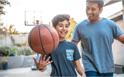 Dad and son play basketball