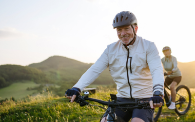  Active senior couple exploring nature on electric bicycles