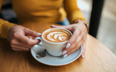 Close-up image of a female drinking latte.
