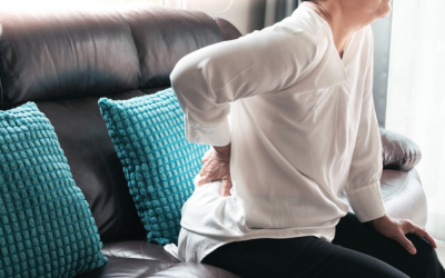 Older woman holds back in pain 