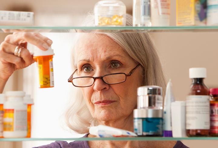 Person cleaning out medicine cabinet 