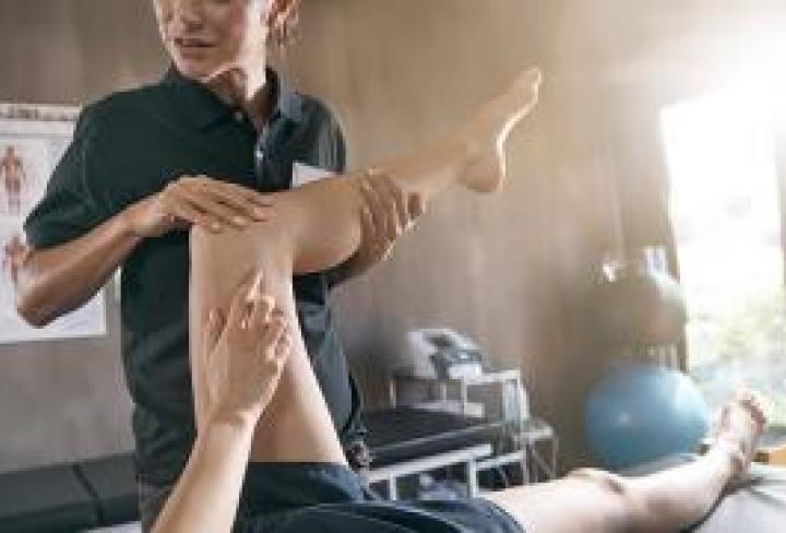 Physical Therapist stretching a patient