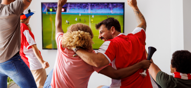 Fans celebrate during soccer match.