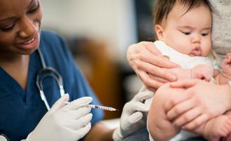 A medical profressional administering a Baby flu shot