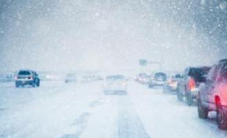 Cars in traffic on a snowy freeway