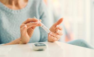 A patient checking their glucose levels with a diabetes monitor 