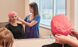 Cancer patient trying a head wrap