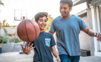 Adult and child playing with a basketball