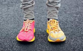 A close-up of a person's feet wearing running shoes