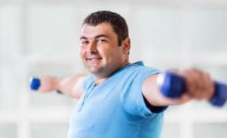 Person doing lateral raises with dumbells