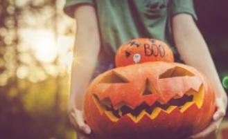 Child holding jack-o-lanterns