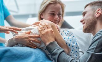 Parents holding newly born baby