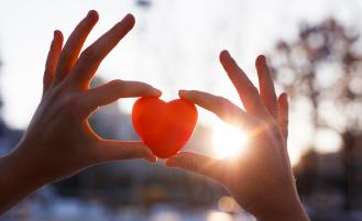 Hands holding a red heard shape