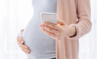 Pregnant person making a phone call