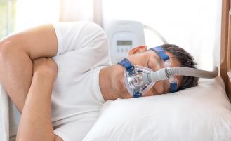 Patient sleeping with apnea mask