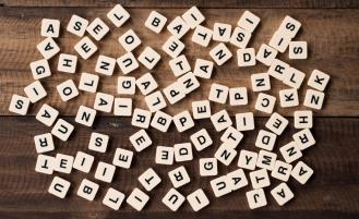 Small tiles with letters scattered across table