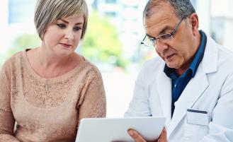 male-doctor-looking-over-results-with-female-patient