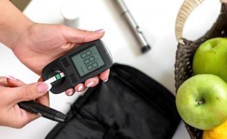 person-with-glucose-monitor-checking-blood-sugar