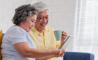 older-asian-couple-sitting-smiling