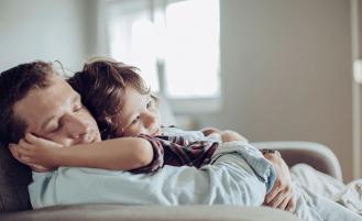 young-boy-held-by-father