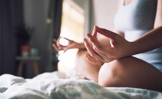 woman-sitting-cross-legged-meditating