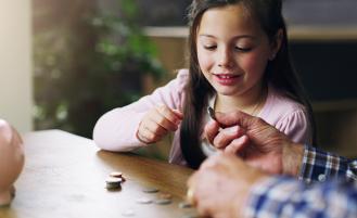 young-girl-counting-money-piggy-bank