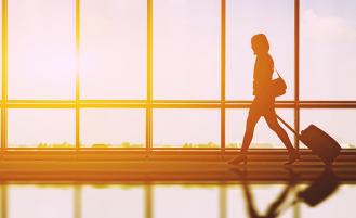 woman-walks-with-suitcase-in-airport