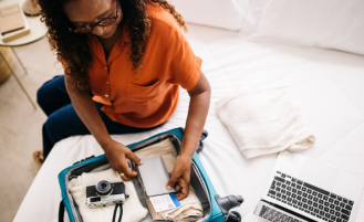 Retired woman packs suitcase.