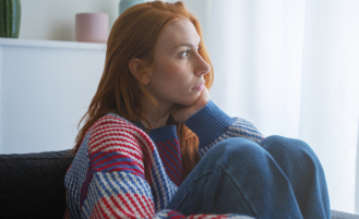 Woman looks out window.
