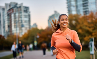 Woman runs outside in city.