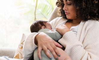 Mother breastfeeds child.